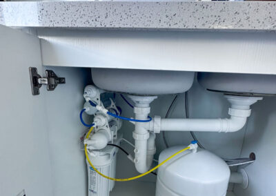 a sink with pipes and water filter