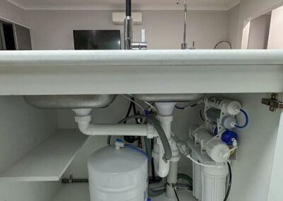 a sink with pipes and faucet